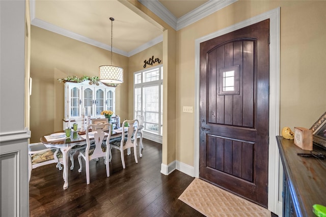 foyer entrance featuring dark wood finished floors, crown molding, and baseboards