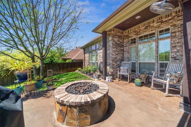 view of patio / terrace featuring fence and a fire pit