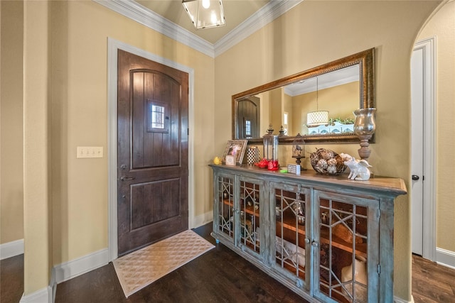foyer with baseboards, crown molding, and dark wood-style floors