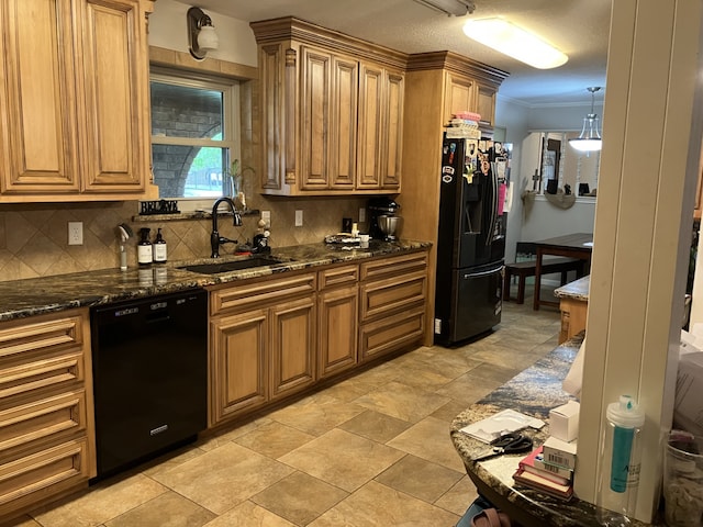 kitchen featuring dark stone counters, black appliances, decorative backsplash, and a sink