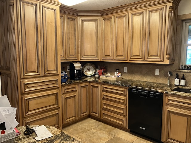kitchen featuring dark stone counters, decorative backsplash, brown cabinets, dishwasher, and light tile patterned floors