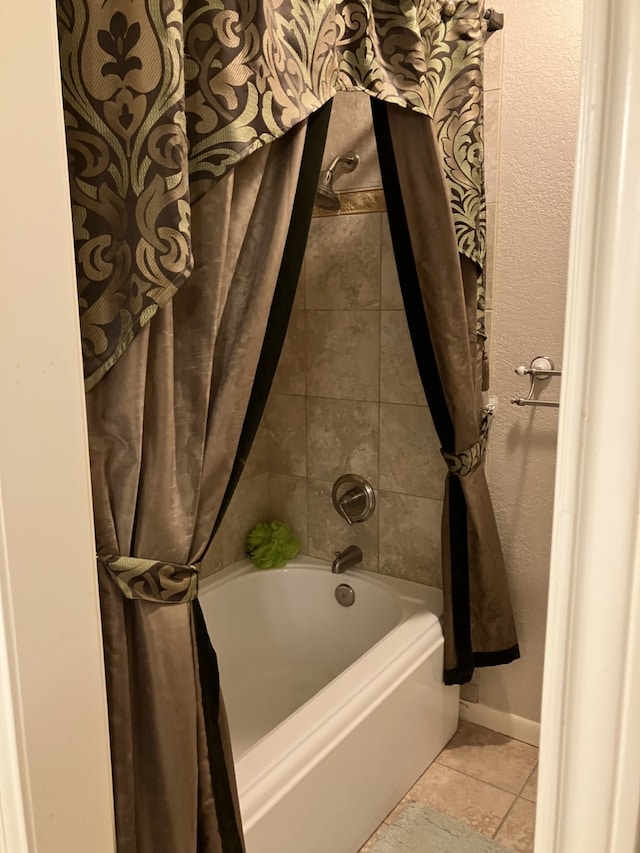 full bathroom with tile patterned floors and shower / bath combo with shower curtain