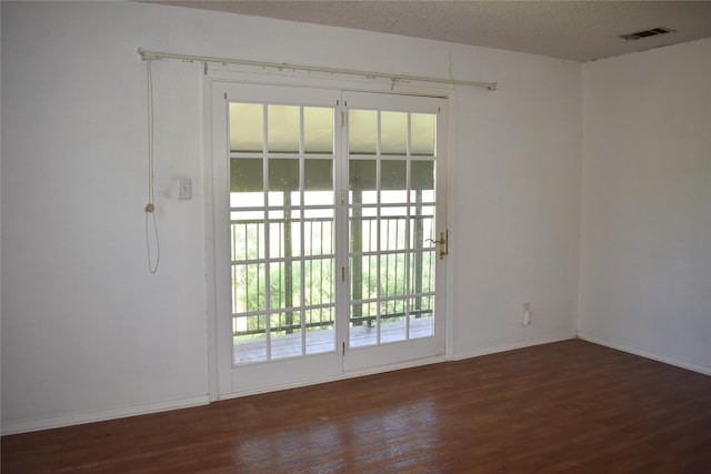 4912 Williford Rd, Sachse, TX 75048 - unfurnished room featuring visible vents, wood finished floors, and baseboards