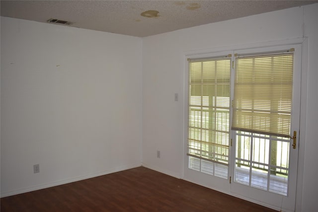 4912 Williford Rd, Sachse, TX 75048 - spare room featuring a textured ceiling, wood finished floors, visible vents, and baseboards