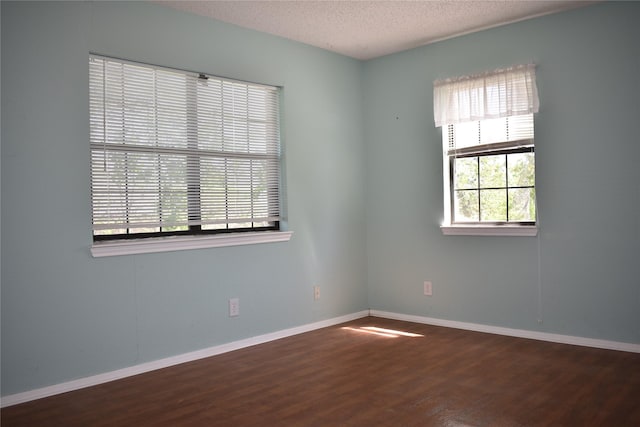 4912 Williford Rd, Sachse, TX 75048 - unfurnished room featuring a textured ceiling, wood finished floors, and baseboards