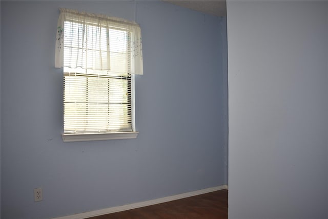 4912 Williford Rd, Sachse, TX 75048 - spare room featuring wood finished floors and baseboards