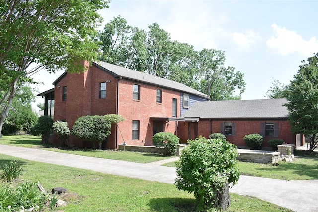 4912 Williford Rd, Sachse, TX 75048 - view of front of house with a front yard and brick siding