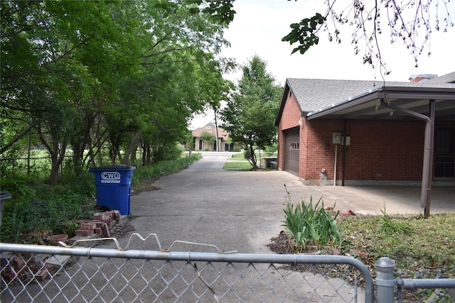4912 Williford Rd, Sachse, TX 75048 - view of home's exterior featuring fence, driveway, brick siding, and an attached garage