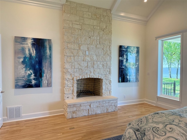 unfurnished bedroom with baseboards, ornamental molding, wood finished floors, and visible vents