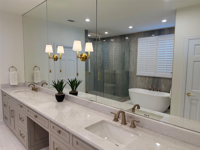 full bathroom featuring double vanity, visible vents, a stall shower, and a sink