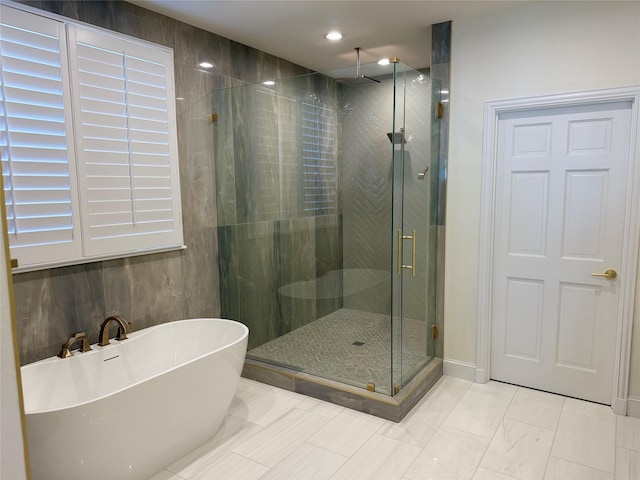 bathroom featuring a soaking tub, recessed lighting, and a stall shower
