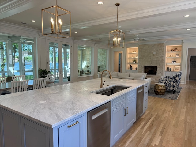 kitchen featuring dishwasher, a stone fireplace, ornamental molding, and a sink