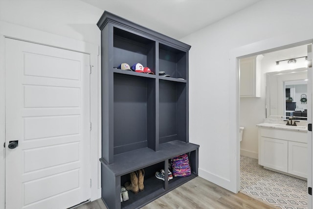 3728 George Owens Rd, Ponder, TX 76259 - mudroom with light wood-style flooring, baseboards, and a sink