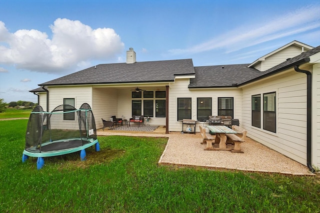 3728 George Owens Rd, Ponder, TX 76259 - rear view of property with a trampoline, a patio area, a yard, a chimney, and ceiling fan