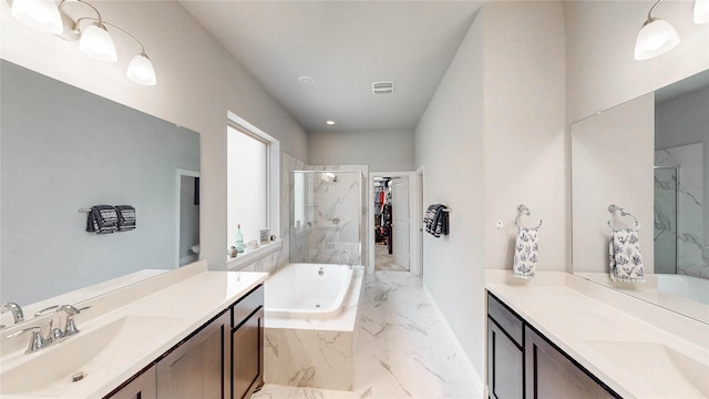 full bathroom with a marble finish shower, two vanities, a sink, visible vents, and marble finish floor