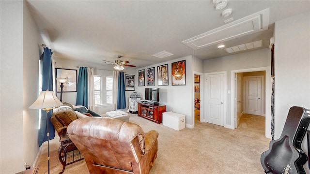 living area featuring a ceiling fan, attic access, light carpet, baseboards, and visible vents