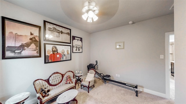interior space with carpet, a ceiling fan, and baseboards