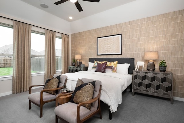 bedroom featuring tile walls, ceiling fan, and carpet flooring