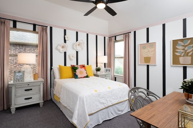 bedroom with dark carpet, a ceiling fan, and multiple windows