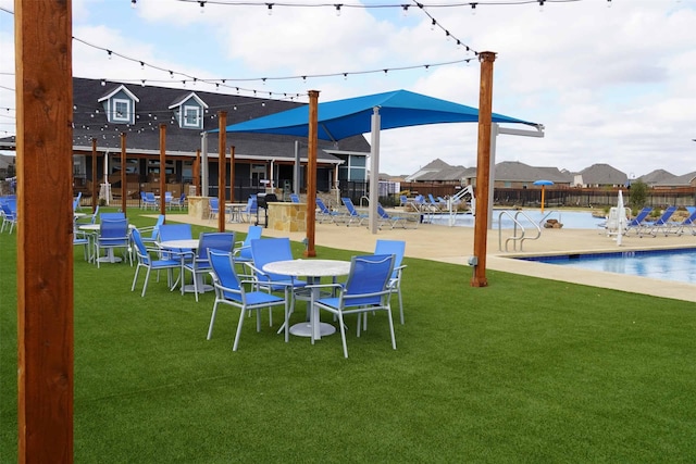exterior space with a community pool and fence