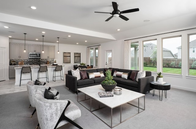 living room with recessed lighting, a ceiling fan, and baseboards