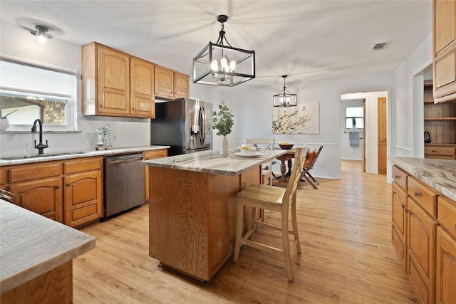 6245 Century Dr, Kennedale, TX 76060 - kitchen with stainless steel appliances, visible vents, a sink, a kitchen island, and a kitchen bar