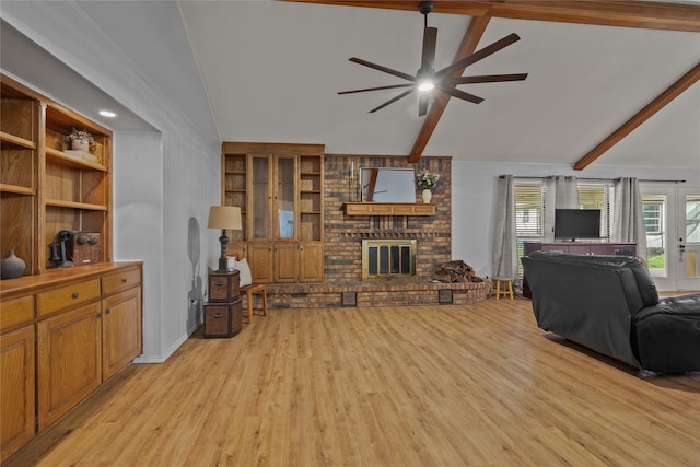 6245 Century Dr, Kennedale, TX 76060 - living area featuring lofted ceiling with beams, a ceiling fan, a brick fireplace, and light wood-style flooring