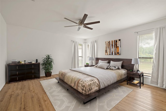 6245 Century Dr, Kennedale, TX 76060 - bedroom featuring light wood-style flooring, a ceiling fan, and multiple windows