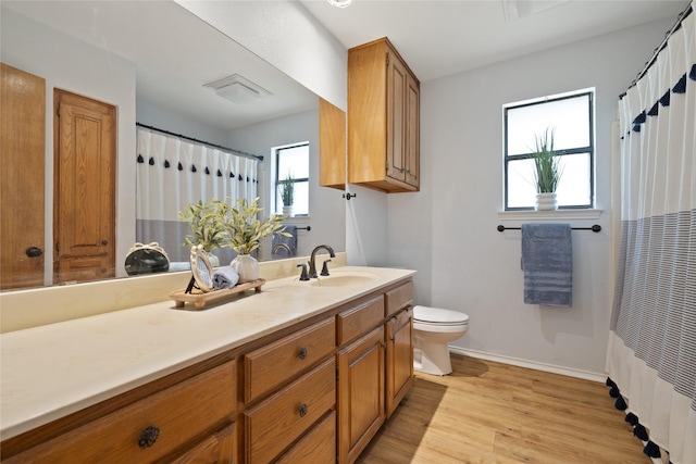 6245 Century Dr, Kennedale, TX 76060 - bathroom with baseboards, wood finished floors, vanity, and toilet