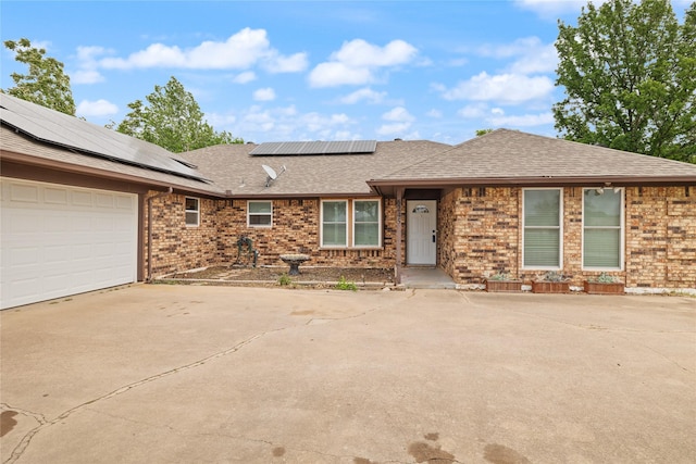 6245 Century Dr, Kennedale, TX 76060 - single story home featuring roof mounted solar panels, brick siding, roof with shingles, and concrete driveway