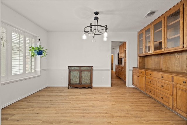 6245 Century Dr, Kennedale, TX 76060 - unfurnished dining area featuring light wood finished floors, baseboards, visible vents, and an inviting chandelier