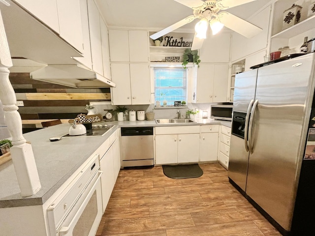 107 N Main St, Crandall, TX 75114 - kitchen featuring white cabinets, stainless steel appliances, open shelves, a sink, and light wood-type flooring