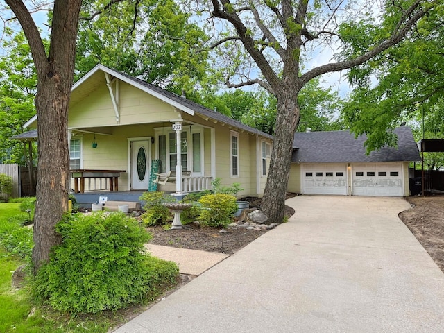 107 N Main St, Crandall, TX 75114 - view of front of home with a detached garage, driveway, a shingled roof, fence, and a porch