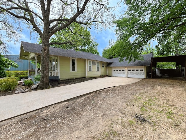 107 N Main St, Crandall, TX 75114 - single story home featuring concrete driveway, roof with shingles, a carport, and a garage