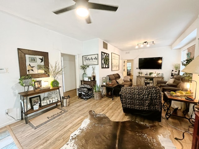 107 N Main St, Crandall, TX 75114 - living room featuring wood finished floors, visible vents, and ceiling fan