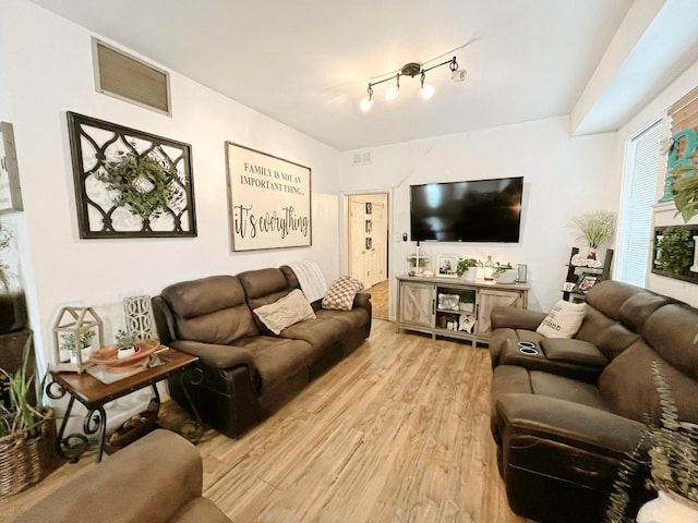 107 N Main St, Crandall, TX 75114 - living room featuring track lighting, visible vents, and light wood finished floors