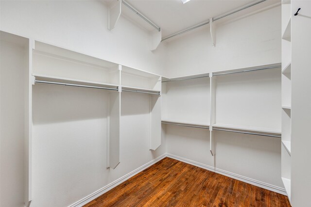 walk in closet with wood finished floors