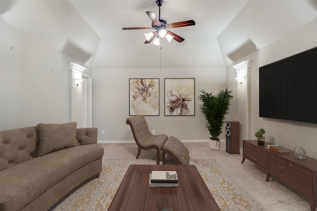 living area featuring baseboards, lofted ceiling, ceiling fan, and light carpet