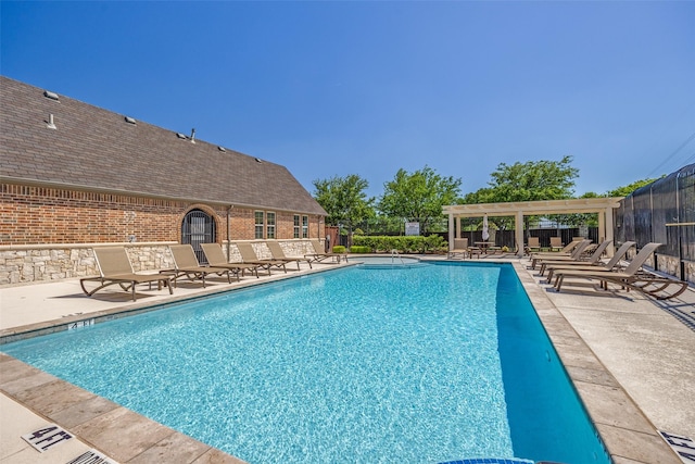 pool with fence, a pergola, and a patio
