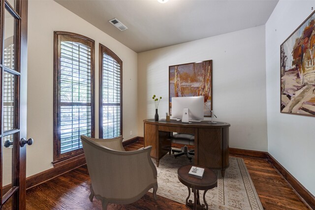 office space with baseboards, visible vents, a wealth of natural light, and dark wood-type flooring