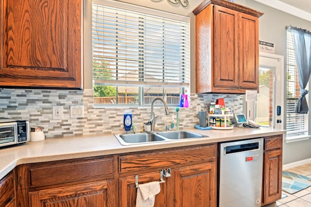 202 Beacon Hill Ln, Forney, TX 75126 - kitchen with stainless steel dishwasher, a sink, light countertops, tasteful backsplash, and crown molding