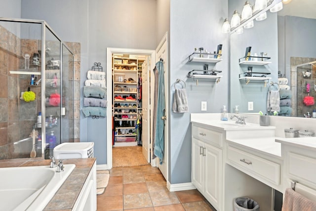 202 Beacon Hill Ln, Forney, TX 75126 - full bathroom with a shower stall, a garden tub, a walk in closet, vanity, and tile patterned floors