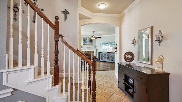 202 Beacon Hill Ln, Forney, TX 75126 - entrance foyer with ceiling fan, arched walkways, ornamental molding, stairs, and light tile patterned floors
