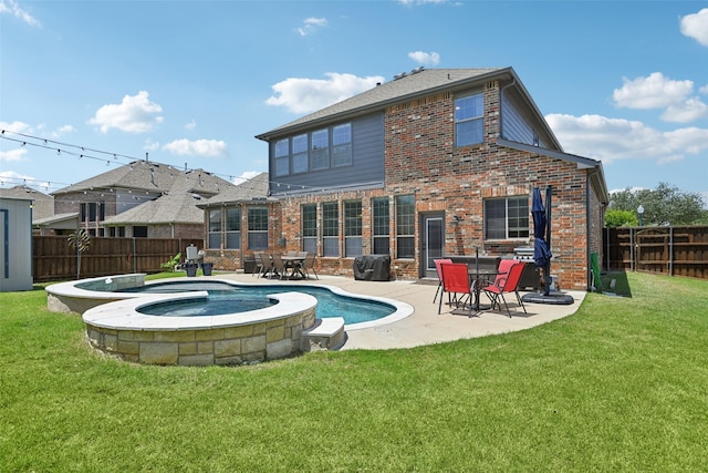 202 Beacon Hill Ln, Forney, TX 75126 - back of house with a fenced backyard, brick siding, a patio, and a pool with connected hot tub