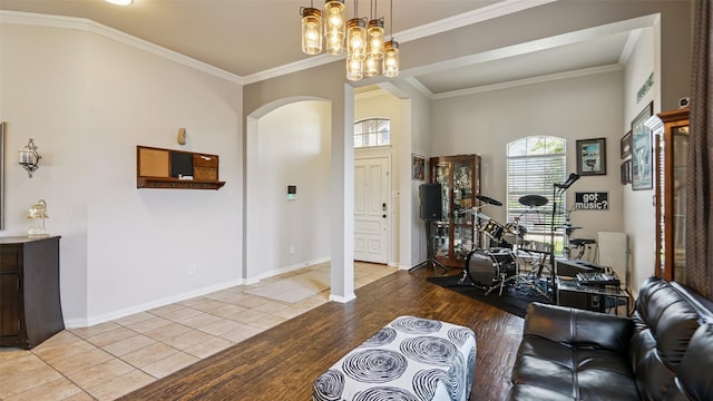 202 Beacon Hill Ln, Forney, TX 75126 - living room with arched walkways, ornamental molding, and wood finished floors