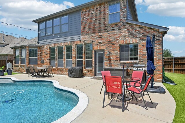 202 Beacon Hill Ln, Forney, TX 75126 - view of pool with a fenced backyard, a pool with connected hot tub, a storage shed, an outbuilding, and a patio area