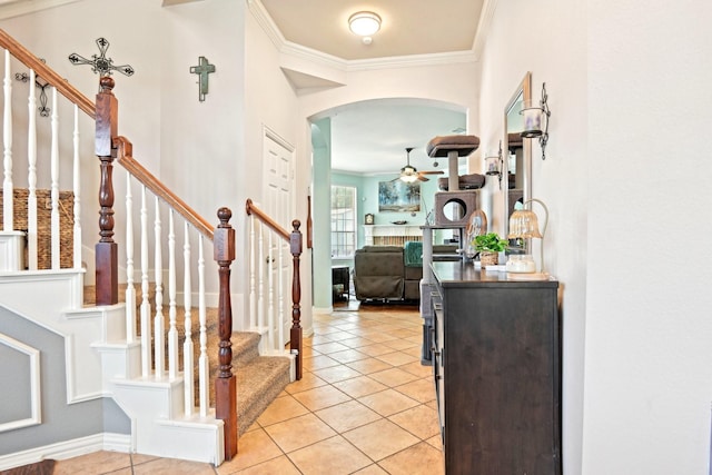 202 Beacon Hill Ln, Forney, TX 75126 - entrance foyer featuring crown molding, arched walkways, light tile patterned flooring, stairs, and a ceiling fan