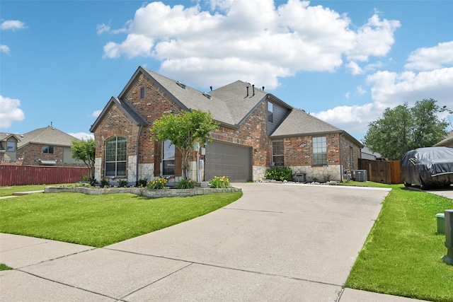 202 Beacon Hill Ln, Forney, TX 75126 - view of front of property with stone siding, concrete driveway, roof with shingles, and brick siding
