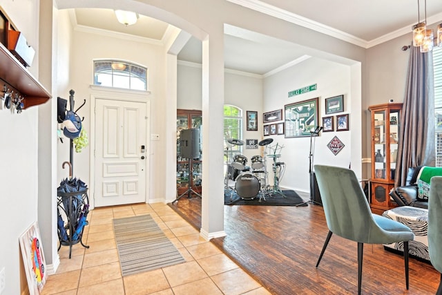 202 Beacon Hill Ln, Forney, TX 75126 - entrance foyer featuring light tile patterned floors, arched walkways, ornamental molding, and baseboards