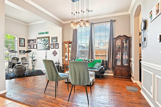 202 Beacon Hill Ln, Forney, TX 75126 - dining space featuring wood finished floors, ornamental molding, arched walkways, and baseboards